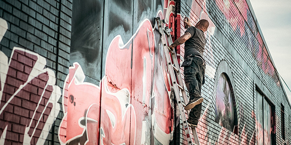 Development innovative solutions for urban regeneration Man drawing graffiti