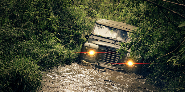 Protection and risk management in case of floods and landslides Jeep running in the mud