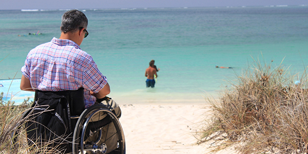 Accessibility increase for tourists with special needs Man with disability by the sea