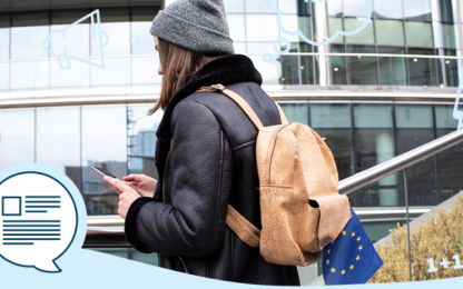 girl with backpack is looking at the smartphone